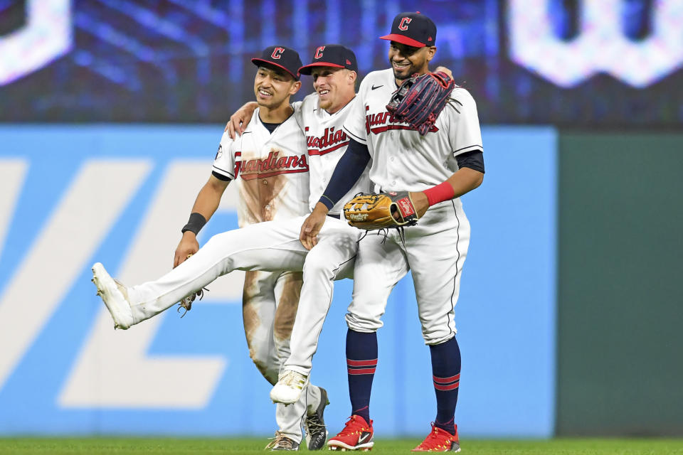 FILE - Cleveland Guardians' Steven Kwan, left, Myles Straw, center, and Oscar Mercado celebrate the team's 4-0 win over the Texas Rangers in a baseball game, Wednesday, June 8, 2022, in Cleveland. Under manager Terry Francona, baseball’s youngest team — the Guardians' average batting age (26.1) and average pitching age (26.5) are below Triple-A averages — is having fun while also developing into a playoff contender sooner than expected. (AP Photo/Nick Cammett, FIle)