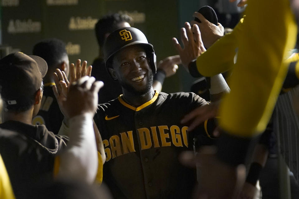 San Diego Padres' Jurickson Profar celebrates in the dugout after scoring off a single by Jake Cronenworth during the third inning of a baseball game against the Chicago Cubs Monday, June 13, 2022, in Chicago. (AP Photo/Charles Rex Arbogast)