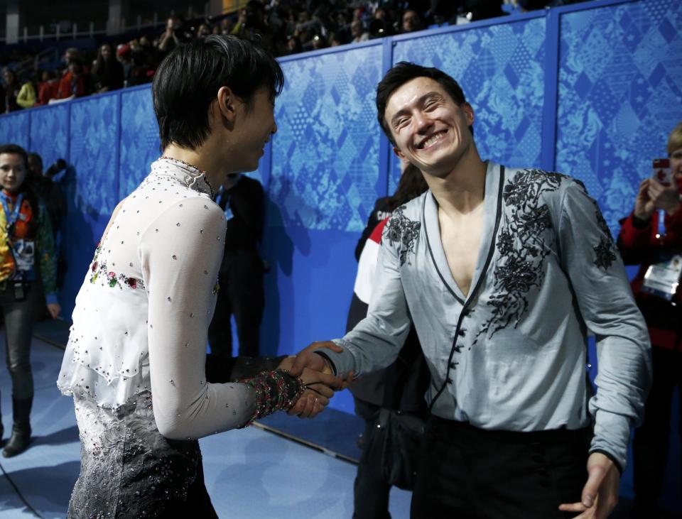 Hanyu shakes hands with Chan before the flower ceremony during the Figure Skating Men's Free Skating Program at the Sochi 2014 Winter Olympics