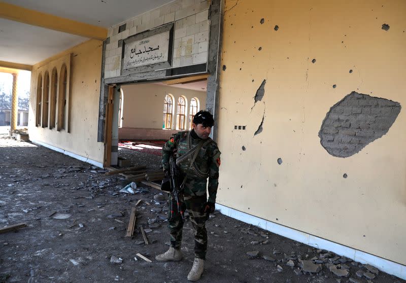 An Afghan National Army soldier inspects a damaged mosque at the site of an attack in a U.S. military air base in Bagram