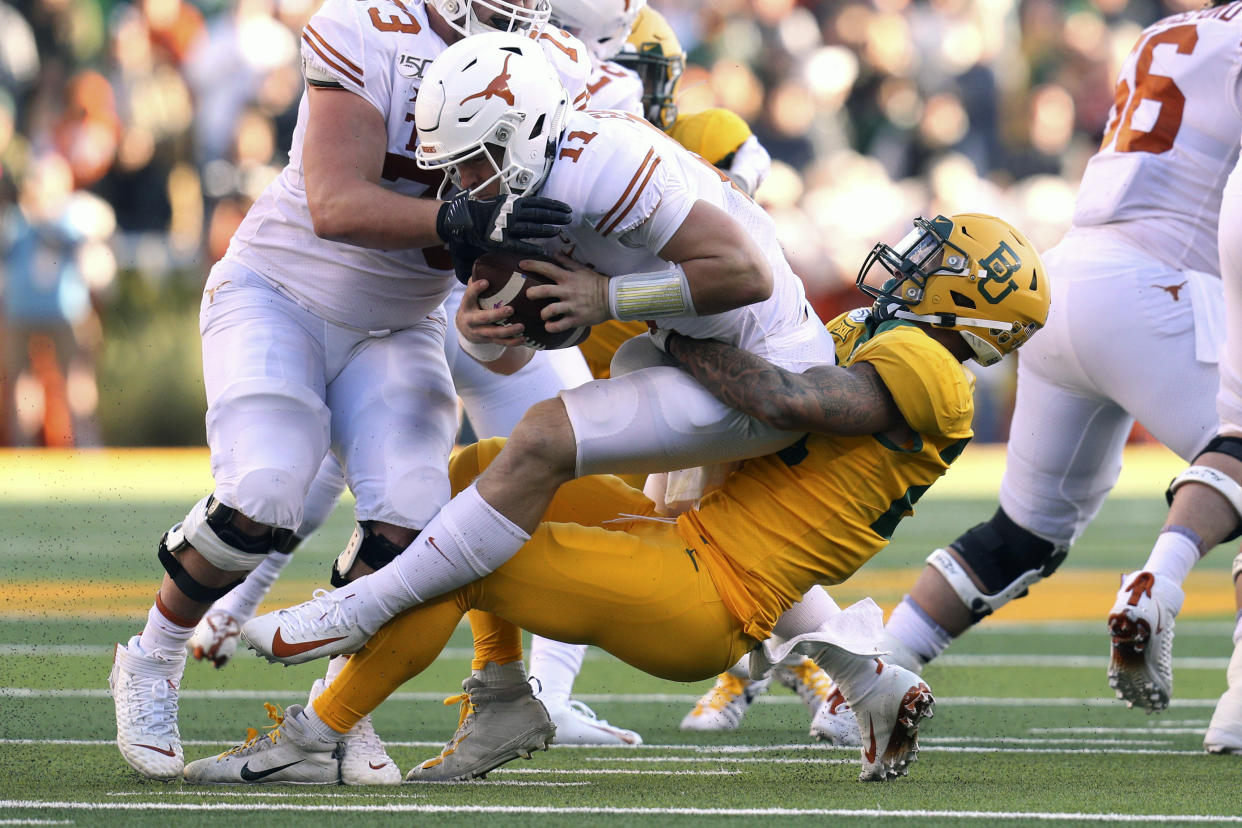 Texas quarterback Sam Ehlinger (11) is sacked by Baylor linebacker Terrel Bernard (26) in the first half of an NCAA college football game Saturday, Nov. 23, 2019, in Waco, Texas. (AP Photo/Richard W. Rodriguez)