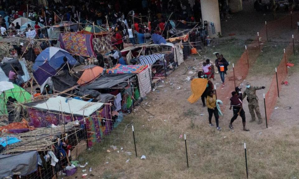 Migrants are routed out of a makeshift border camp after being processed in Del Rio, Texas.