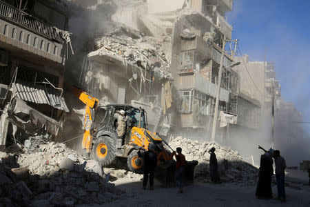 A front loader removes debris in a damaged site after airstrikes on the rebel held Tariq al-Bab neighbourhood of Aleppo, Syria September 24, 2016. REUTERS/Abdalrhman Ismail