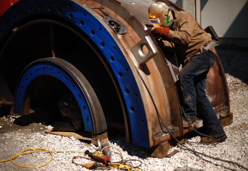 A welder works on a gas turbine at Gainesville Regional Utilities' Kelly Power Station in 2014.