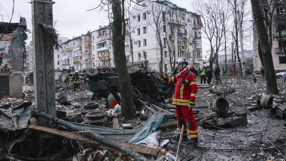 A fireman stands near the place where the rocket hit, in Kharkiv, Ukraine, on January 2, 2023. - Pavlo Pakhomenko/NurPhoto/AP