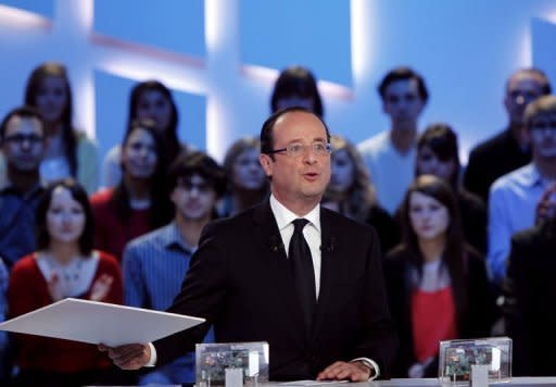 France's Socialist Party (PS) presidential candidate Francois Hollande takes part in the TV show "Le grand journal" on a set of French TV Canal+