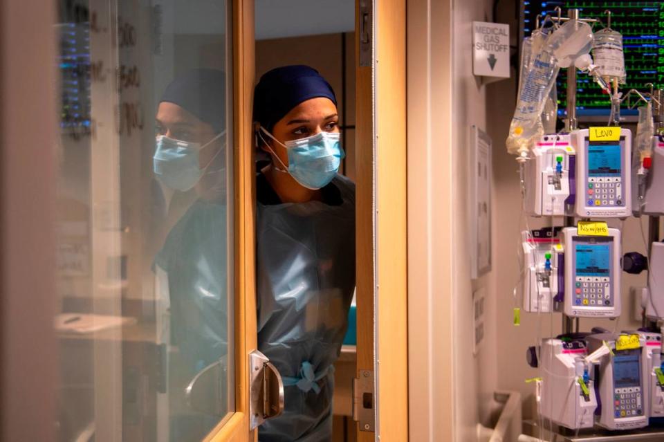 A nurse peers out of a COVID-19 patient’s room in the ICU at Memorial Hospital in Gulfport on Wednesday, Aug. 11, 2021. Hospitals along the MS Gulf Coast have few to no ICU beds available.