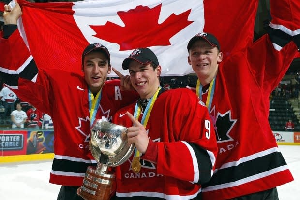 Patrice Bergeron, left, Sidney Crosby, centre, and Corey Perry of Team Canada celebrate their gold-medal win after beating Team Russia at the World Juniors on Jan. 4, 2005, in Grand Forks, North Dakota. Canada defeated Russia 6-1.