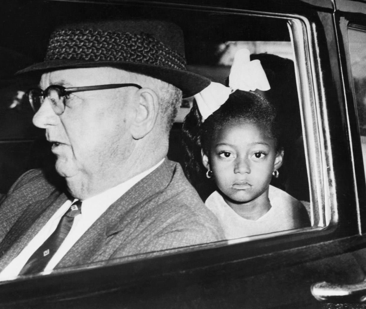 <span class="caption">A U.S. Federal Marshal escorts Gail Etienne to her first day of school on Nov. 14, 1960.</span> <span class="attribution"><a class="link " href="https://www.gettyimages.com/detail/news-photo/first-grade-negro-girl-is-escorted-by-us-federal-marshals-news-photo/507249693?adppopup=true" rel="nofollow noopener" target="_blank" data-ylk="slk:Underwood Archives/Getty Images;elm:context_link;itc:0;sec:content-canvas"> Underwood Archives/Getty Images</a></span>