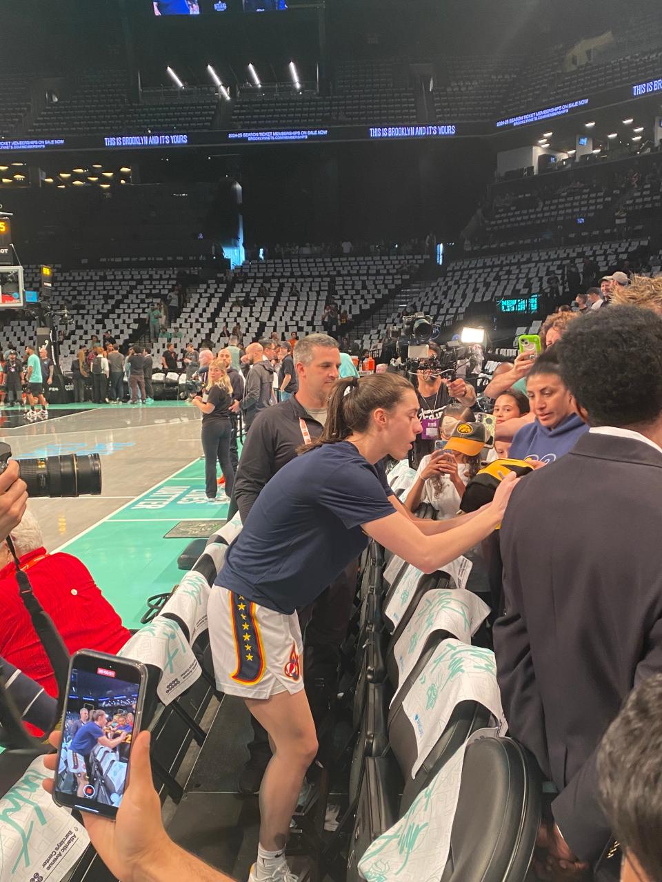Indiana Fever star Caitlin Clark signs autographs Saturday, May 18, 2024 before her team's game against the New York Liberty at Barclays Center in New York, N.Y.