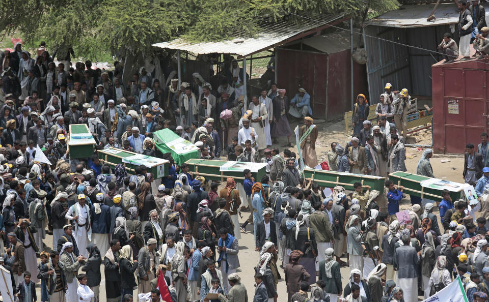 Yemeni people carry the coffins of victims of a Saudi-led airstrike, during a funeral in Saada, Yemen, Monday, Aug. 13, 2018. Yemen's shiite rebels are backing a United Nations' call for an investigation into the airstrike in the country's north that killed dozens of people including many children. (AP Photo/Hani Mohammed)