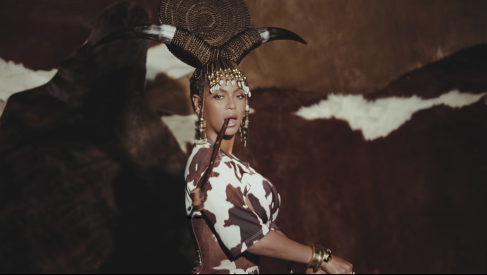 An image of Beyonce from Black Is King with a braided hairstyle and cow horns