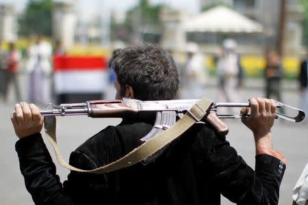 An armed man loyal to the Houthi movement holds his weapon as he gathers to protest against the Saudi-backed exiled government deciding to cut off the Yemeni central bank from the outside world, in the capital Sanaa, Yemen August 25, 2016. REUTERS/Mohamed al-Sayaghi