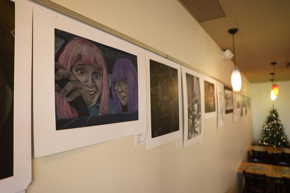 Artwork from local high school students decorates the wall in the newly opened Ocelot Café and Bakery in Richfield.