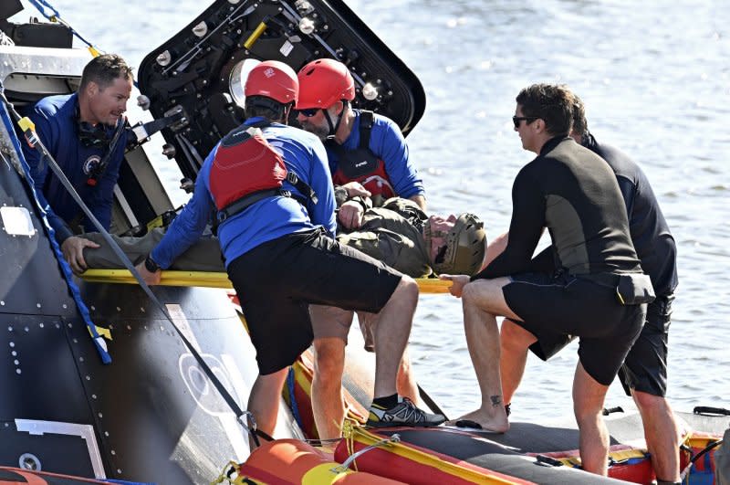 Divers practice removing a disabled astronaut as NASA and Department of Defense teams conduct recovery training with a test article of the Orion spacecraft in the Turning Basin at the Kennedy Space Center in Florida on Feb. 6. File Photo by Joe Marino/UPI