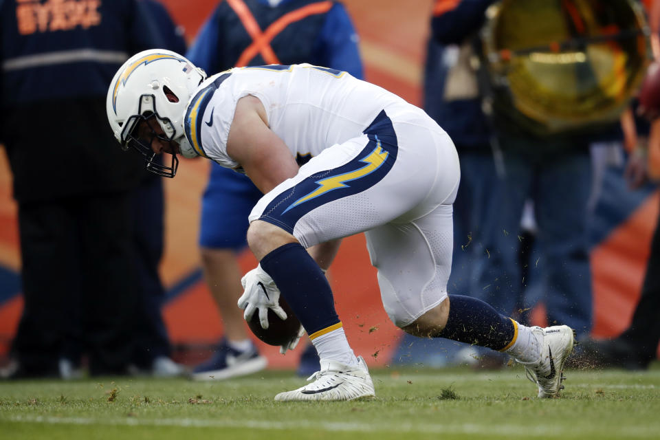 Los Angeles Chargers outside linebacker Kyle Emanuel picks up a fumble on his way to scoring a touchdown during the first half of an NFL football game against the Denver Broncos, Sunday, Dec. 30, 2018, in Denver. (AP Photo/David Zalubowski)