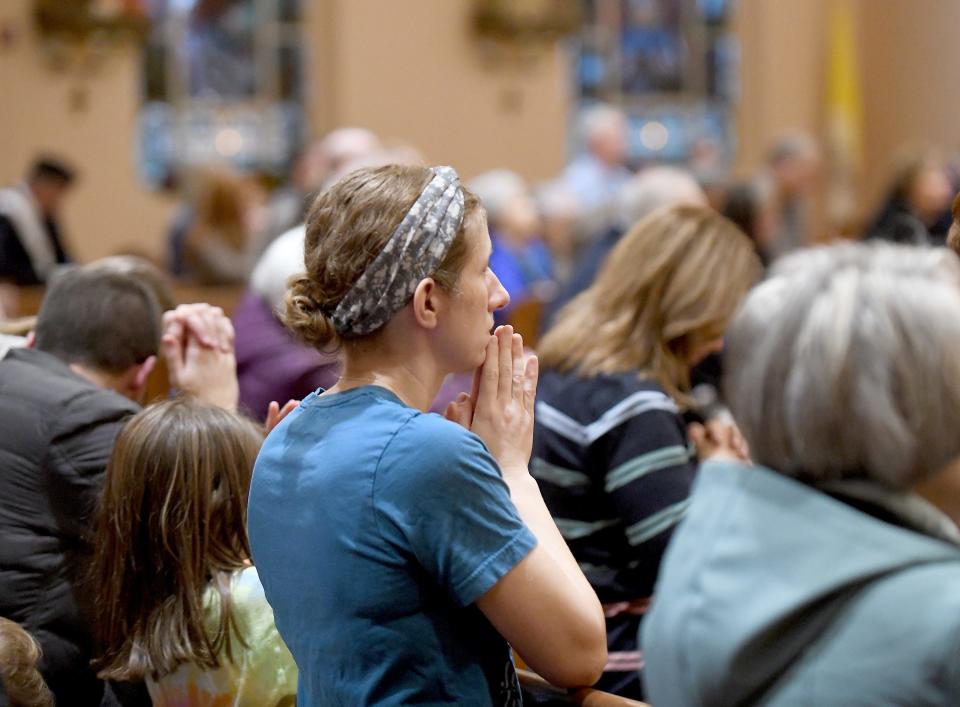 Ellen Kenst of North Canton prays Tuesday as The Most Rev. David J. Bonnar, bishop of the Catholic Diocese of Youngstown, celebrates the late Pope Emeritus Benedict XVI during a Mass at St. Paul Catholic Church in North Canton.