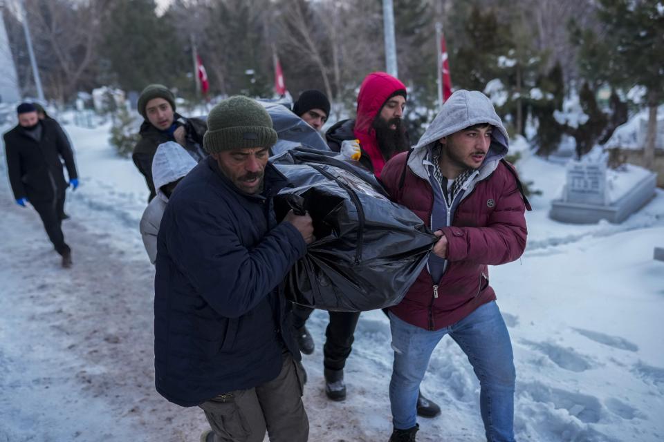 FILE - The son, right, and friends of Syrian refugee Naziha Al-Ahmad carry her body to be buried in a cemetery after she died during an earthquake, in Elbistan, southeastern, Turkey, Friday, Feb. 10, 2023. For Syrians and Ukrainians fleeing the violence back home, the earthquake that struck in Turkey and Syria is but the latest tragedy. The U.N. says Turkey hosts about 3.6 million Syrians who fled their country’s 12-year civil war, along with close to 320,000 people escaping hardships from other countries. (AP Photo/Francisco Seco, File)
