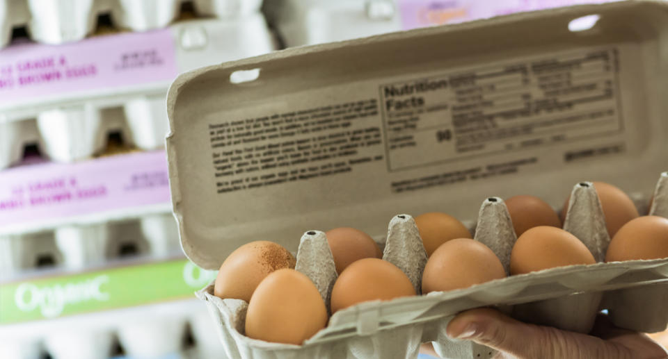 Open carton of eggs in supermarket