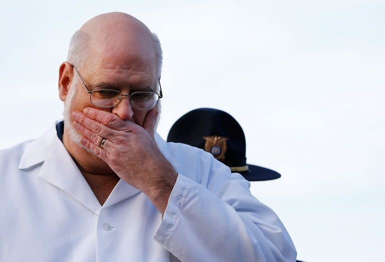 Connecticut Chief Medical Examiner H. Wayne Carver talks to the media about the elementary school shooting during a press conference at Treadwell Memorial Park on December 15, 2012 in Newtown, Connecticut. Most of the 26 people gunned down at a Connecticut elementary school received multiple gunshot wounds from a assault rifle, Carver said