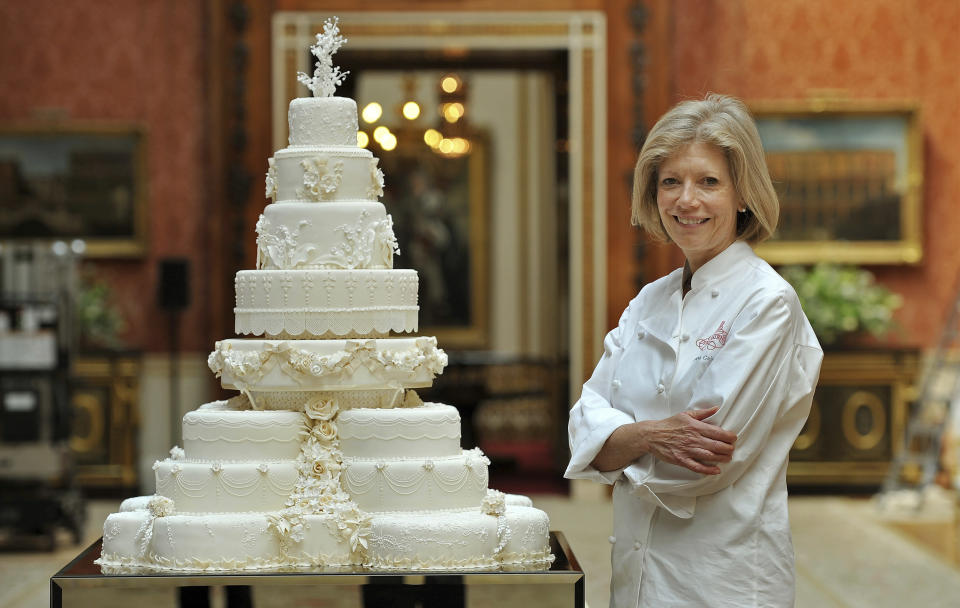 Fiona Cairns poses for a photograph with the wedding cake she and her team made for Prince William and his wife Catherine, the Duchess of Cambridge, in the Picture Gallery inside Buckingham Palace in London April 29, 2011. REUTERS/John Stillwell/Pool