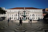 People walk by Rossio square on the first day of the second national lockdown due to coronavirus disease (COVID-19) pandemic in Lisbon