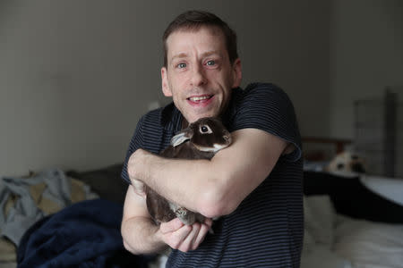 Jacob Levitt holds one of his eight adopted bunnies at his apartment in New York, U.S., April 11, 2019. REUTERS/Shannon Stapleton