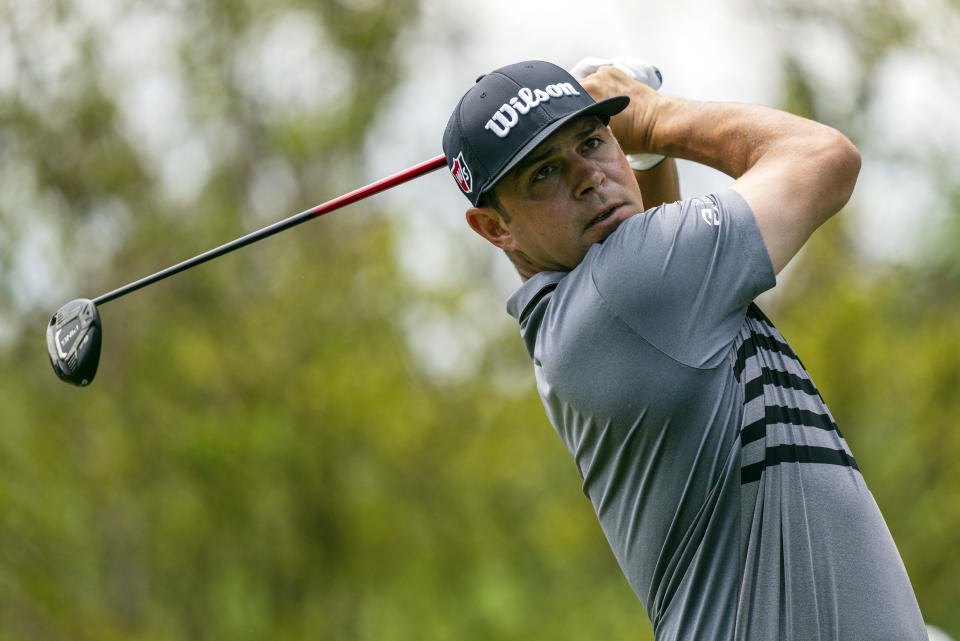 Gary Woodland watches his tee shot on the second hole during the third round of the Wells Fargo Championship golf tournament at Quail Hollow on Saturday, May 8, 2021, in Charlotte, N.C. (AP Photo/Jacob Kupferman)