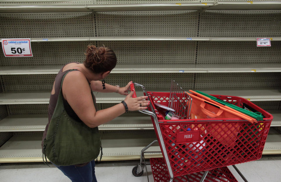 <p>A woman looks at empty shelves that are normally filled with bottles of water after Puerto Rico Governor Ricardo Rossello declared a state of emergency in preparation for Hurricane Irma, in San Juan, Puerto Rico, Sept. 4, 2017. (Photo: Alvin Baez/Reuters) </p>