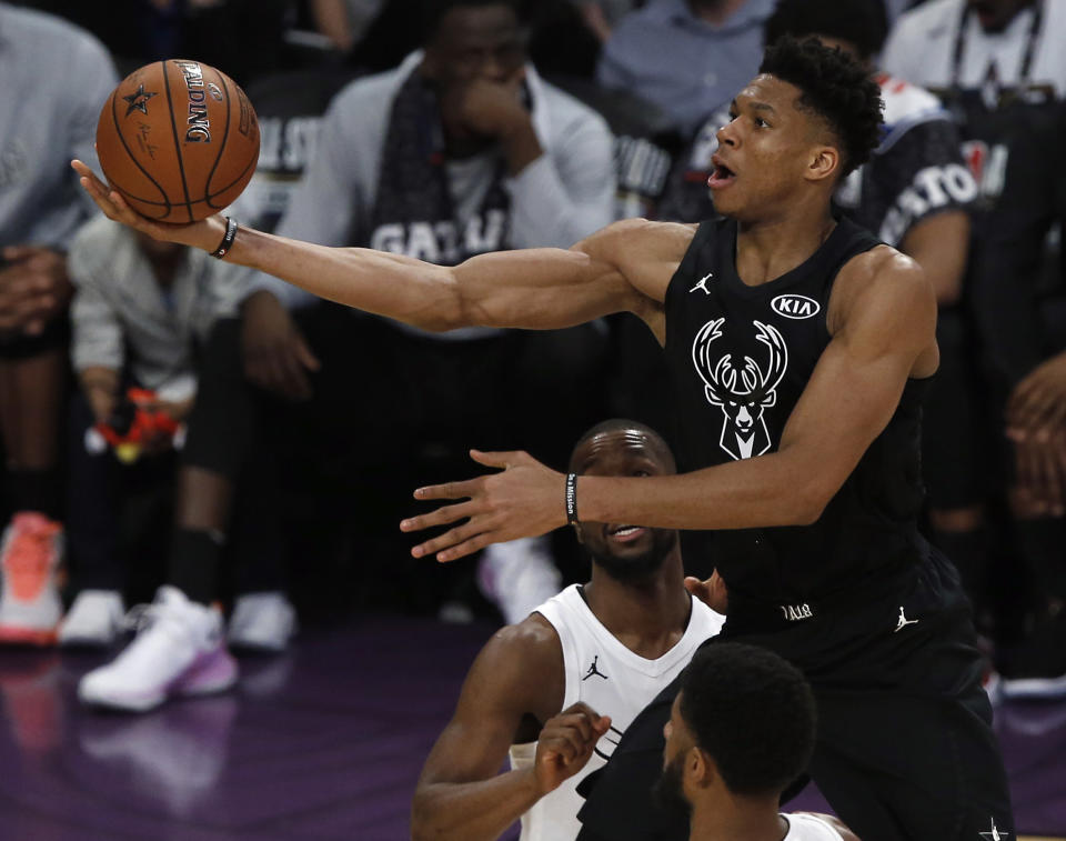 Team Stephen’s forward Giannis Antetokounmpo, right, of the Milwaukee Bucks throws up a shot between Team LeBron’s forward LeBron James, left, of the Cleveland Cavaliers and forward Paul George, bottom center, of the Oklahoma City Thunder during the second half of an NBA All-Star basketball game, Sunday, Feb. 18, 2018, in Los Angeles. (AP Photo/Alex Gallardo)