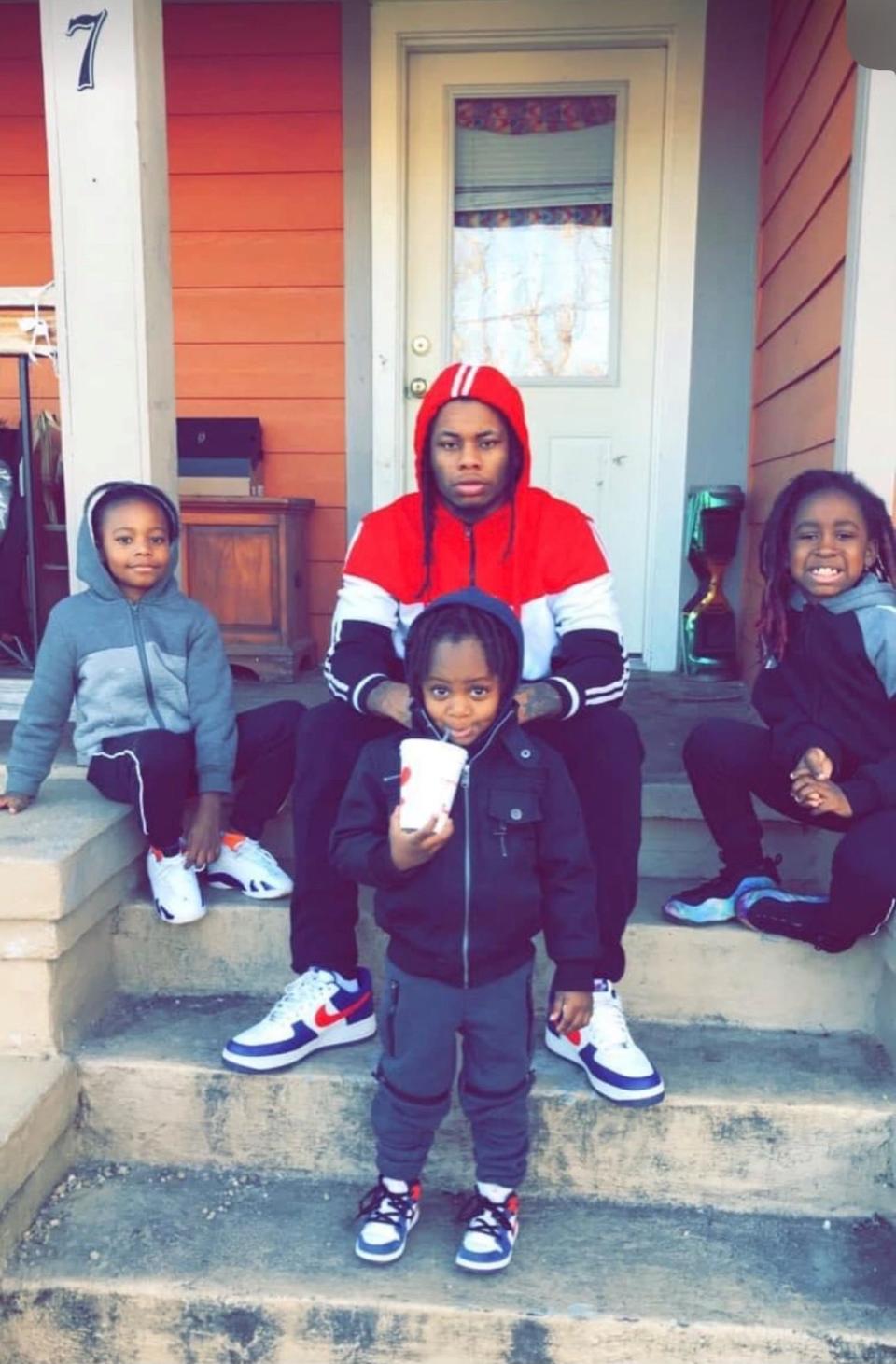 Elijah Timmons III sits with three of his four children. He has a 12-year-old son, 10-year-old son, 6-year-old son and 1-year-old son, according to his mother.