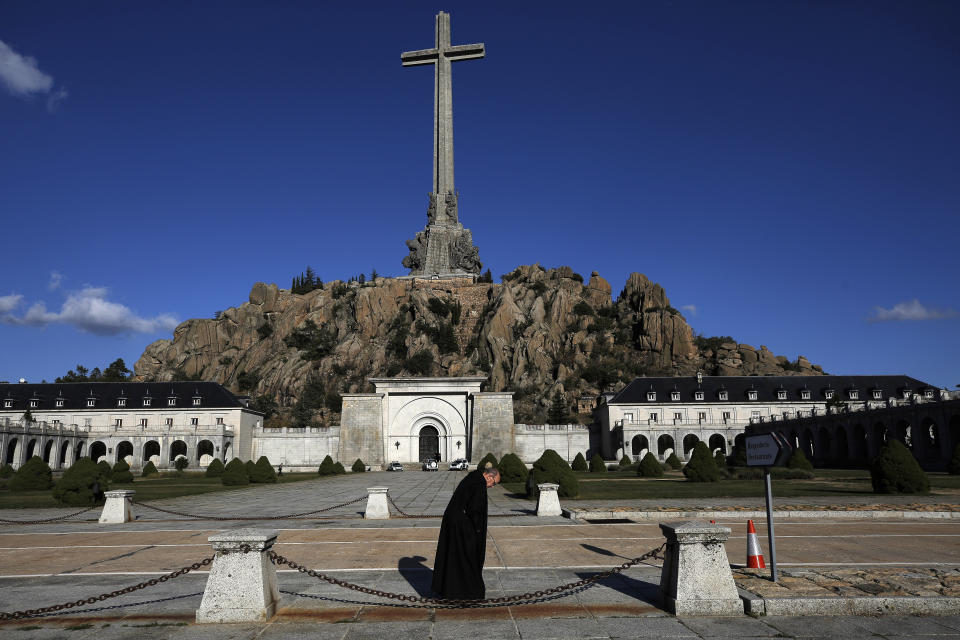 FILE - A friar walks in front of the Valle de los Caidos (Valley of the Fallen) mausoleum on the outskirts of Madrid, Spain, Oct. 13, 201 . The body of José Antonio Primo de Rivera, the founder of Spain's fascist Falange movement, will be exhumed from a Madrid mausoleum on Monday, April 24, 2023 and transferred to a city cemetery. The fascist political leader was executed by Spanish Republicans in November 1936, after Gen. Francisco Franco led an uprising of soldiers in July of that year to bring down Spain's democratically-elected government. (AP Photo/Manu Fernandez, File)