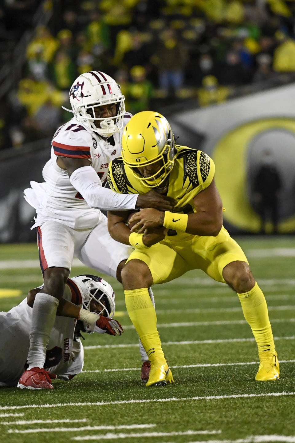 Stony Brook defensive back Carthell Flowers, left, sacks Oregon quarterback Ty Thompson, right, during the fourth quarter of an NCAA college football game Saturday, Sept. 18, 2021, in Eugene, Ore. (AP Photo/Andy Nelson)