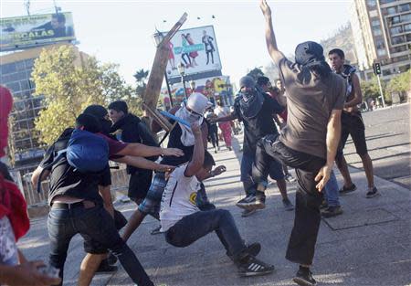 Demonstrators fight each other during the first rally against the government of Michelle Bachelet in Santiago, March 22, 2014. REUTERS/Pablo Sanhueza