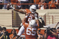 Texas running back Roschon Johnson (2) celebrates his touchdown run against Texas Tech with Jake Majors (65) during the first half of an NCAA college football game on Saturday, Sept. 25, 2021, in Austin, Texas. (AP Photo/Chuck Burton)