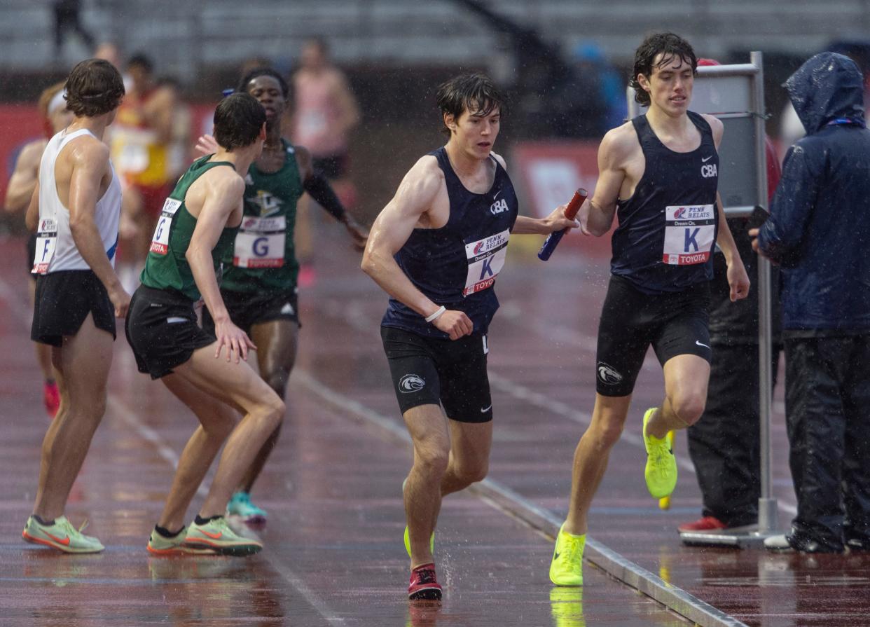 Conor Clifford (right) hands off to NIck Sullivan as CBA took 2nd in the 2023 Penn Relays distance medley