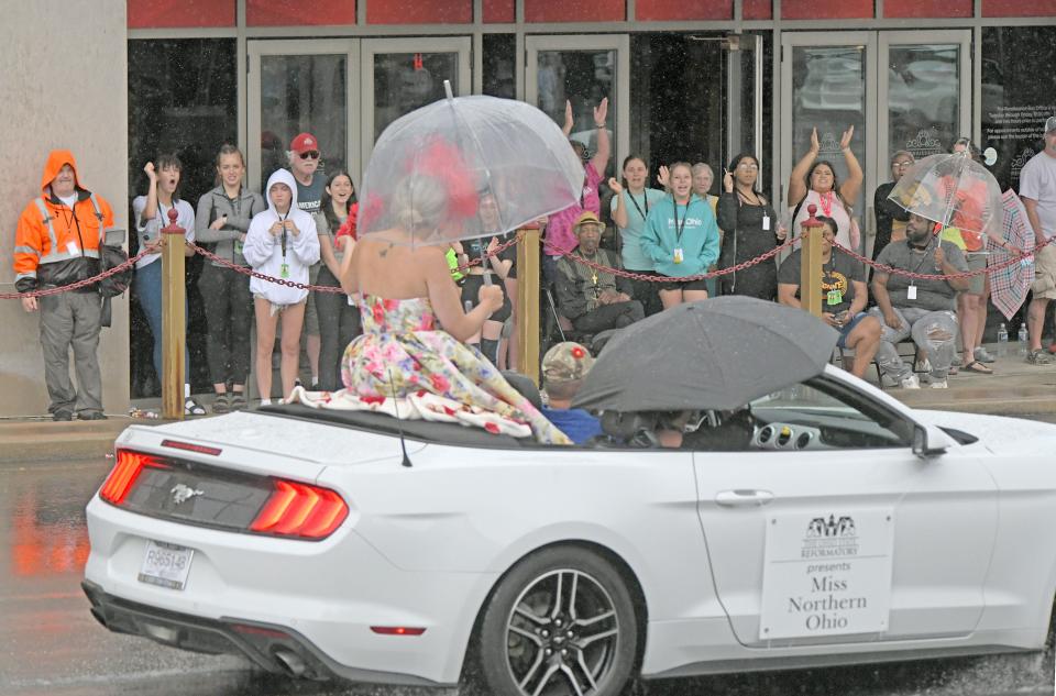 Miss Northern Ohio Megan Riehle receives a warm welcome as she passes the Renaissance Theatre on Sunday during the Miss Ohio Parade.