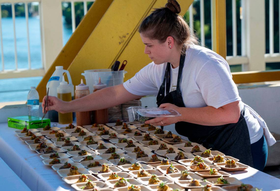 Valarie Voorhees puts final touches on Hors d’oeuvres as guests arrive at the Tower Bridge Dinner on Sunday.