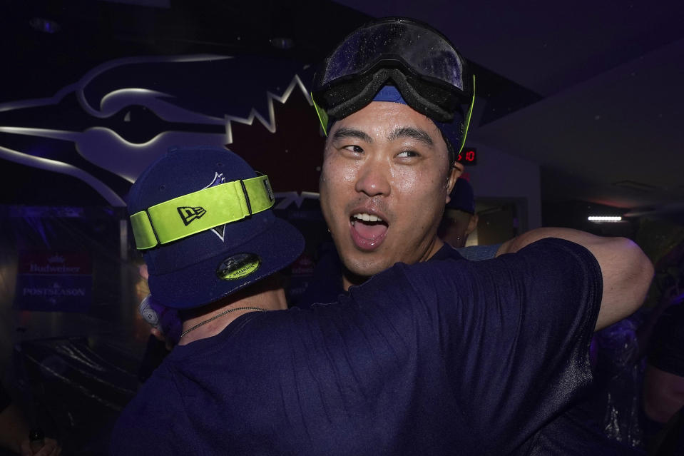 Toronto Blue Jays' Hyun-Jin Ryu celebrates with teammates in the locker room after clinching a berth in the AL wild card series following a baseball game against the Tampa Bay Rays in Toronto, Sunday, Oct. 1, 2023. (Frank Gunn/The Canadian Press via AP)