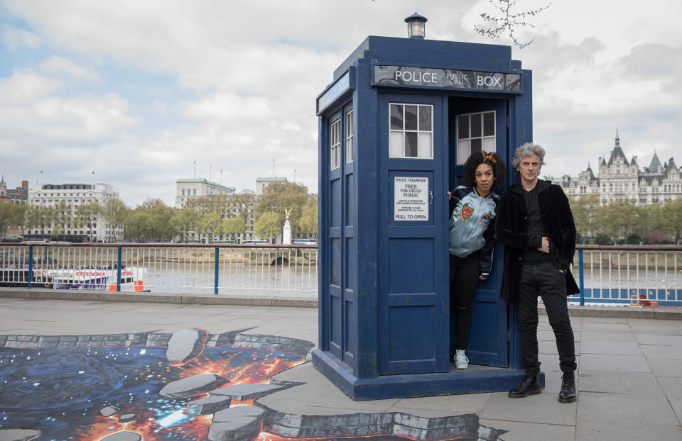 LONDON, ENGLAND - APRIL 12:  To celebrate the new series of 'Doctor Who' which returns to BBC One on Saturday April 15, Peter Capaldi, (The Doctor) and Pearl Mackie (Bill) pose in front of the TARDIS and a huge 3D pavement painting artwork by 3D Joe & Max depicting an alien landscape on the Southbank on April 12, 2017 in London, United Kingdom.  (Photo by Tim P. Whitby/Tim P. Whitby/Getty Images)