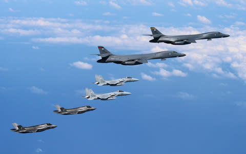 A handout photo made available by the U.S. Air Force through the Japanes Self-Defence Force on 31 August shows U.S Marine Corps F-35B 'Lightning II' stealth fighters (bottom) assigned to the Marine Corps Air Station Iwakuni, Japan, flying alongside two U.S. Air Force B-1B 'Lancer' bombers (up), assigned to the 37th Expeditionary Bomb Squadron, deployed from Ellsworth Air Force Base, South Dakota, over waters near Kyushu, Japan, 31 August - Credit: EPA