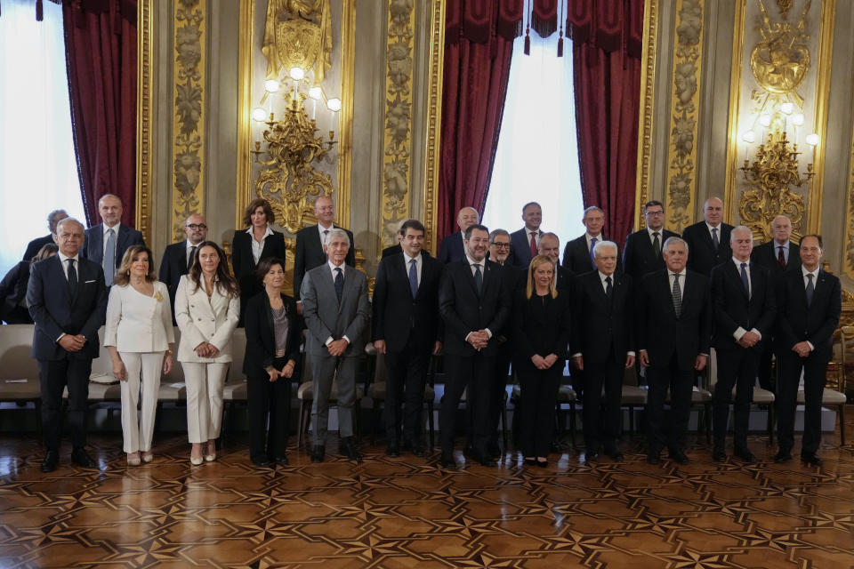 FILE - Newly sworn-in Italian Premier Giorgia Meloni, center, and her cabinet pose for a family photo at Quirinale presidential palace in Rome, Saturday, Oct. 22, 2022. When Giorgia Meloni took office a year ago as the first far-right premier in Italy's post-war history, concern was palpable abroad about the prospect of democratic backsliding and resistance to European Union rules. But since being sworn in as premier on Oct. 22, 2022, Meloni has confounded Western skeptics. (AP Photo/Alessandra Tarantino, File)