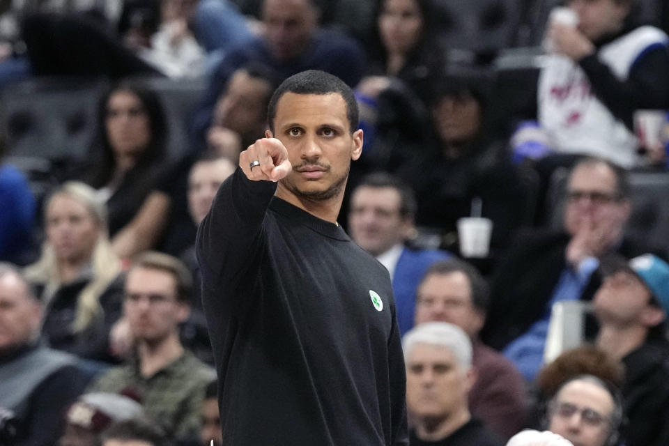 Boston Celtics head coach Joe Mazzulla signals from the sideline during the first half of an NBA basketball game against the Detroit Pistons, Monday, Feb. 6, 2023, in Detroit. (AP Photo/Carlos Osorio)