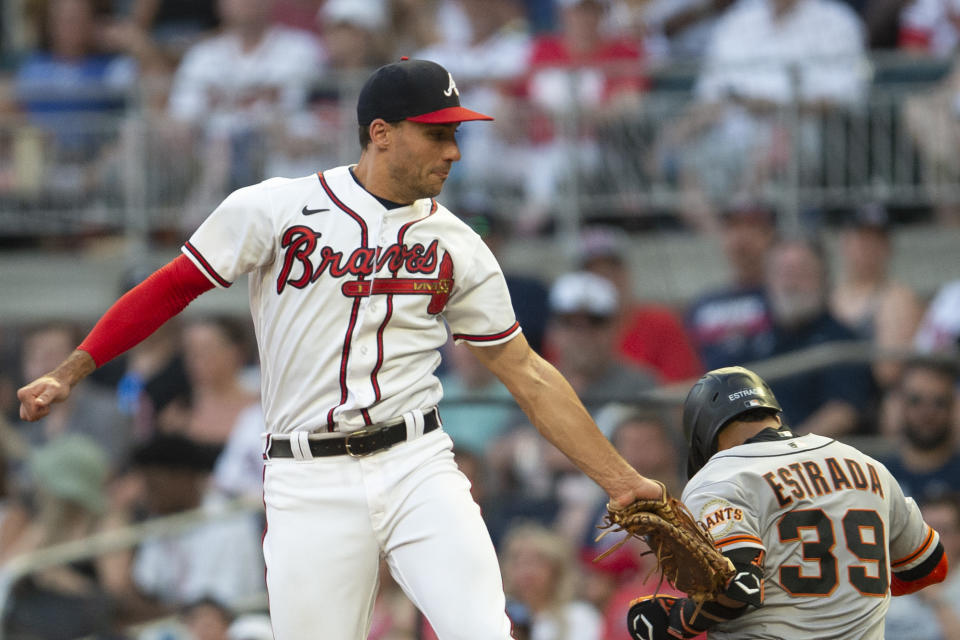 Atlanta Braves first baseman Matt Olson tags San Francisco Giants Thairo Estrada (39) late during the fifth inning of a baseball game Wednesday, June 22, 2022, in Atlanta. (AP Photo/Hakim Wright Sr.)