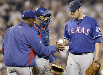 Rangers manager Ron Washington takes the ball from Colby Lewis during a sixth-inning pitching change in Game 3 of the ALCS