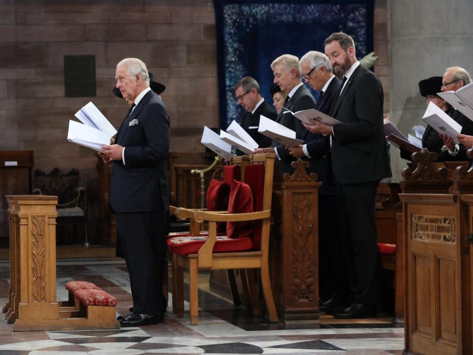 King Charles stands in a chapel in Northern Ireland for a service of reflection in the Queen's honor.