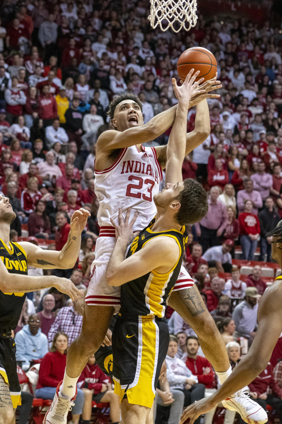 Indiana forward Trayce Jackson-Davis (23) shoots over Iowa's Filip Rebraca during the second half of an NCAA college basketball game against Iowa, Tuesday, Feb. 28, 2023, in Bloomington, Ind. (AP Photo/Doug McSchooler)