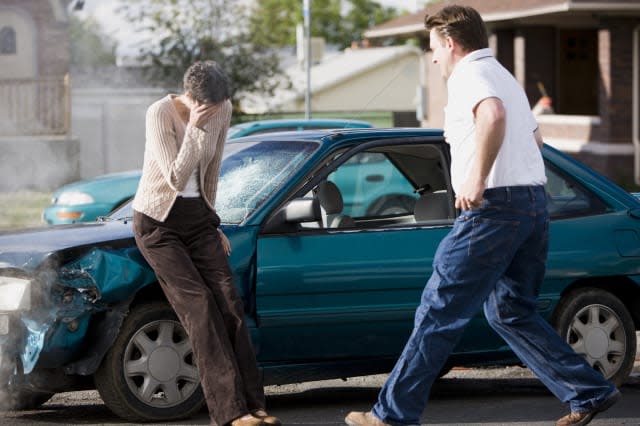 man helping a woman after a car accident