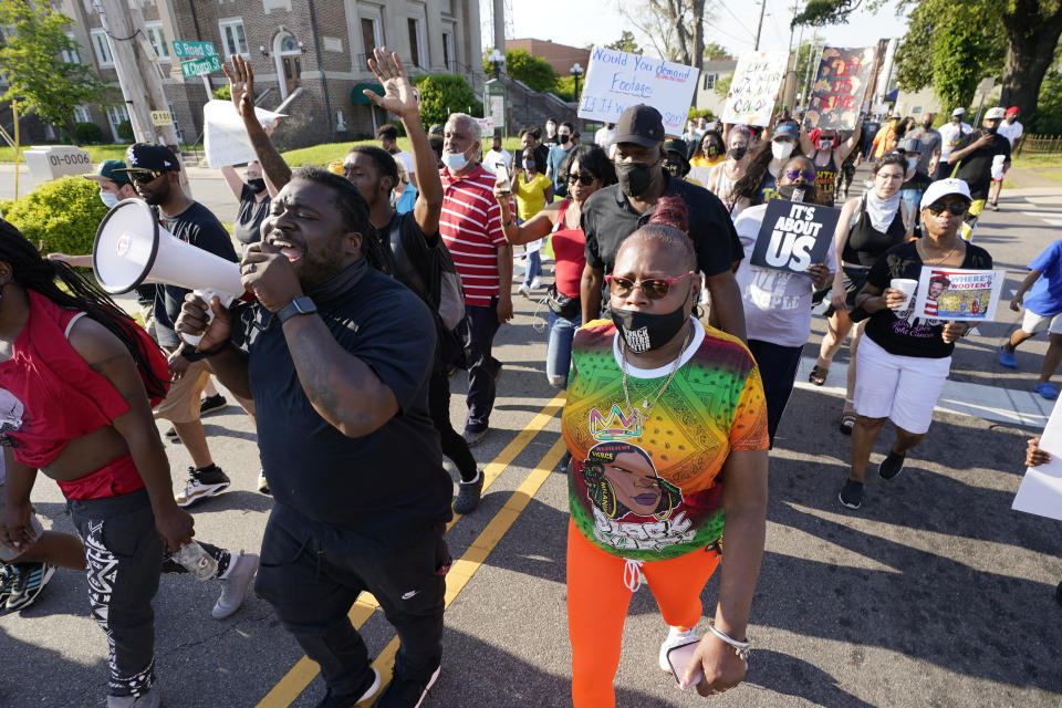 FILE - In this April 28, 2021 file photo, protesters march along the streets to protest the shooting of Andrew Brown Jr. in Elizabeth City, N.C. The fatal shooting of a Black man by sheriff’s deputies has sent shock waves through Elizabeth City. The majority Black city in the state’s rural northeastern corner holds an important place in African American history in the 19th and 20th centuries. But some residents say it seemed too close-knit and too out-of-the-way to become a flashpoint in the 21st. (AP Photo/Steve Helber, File)