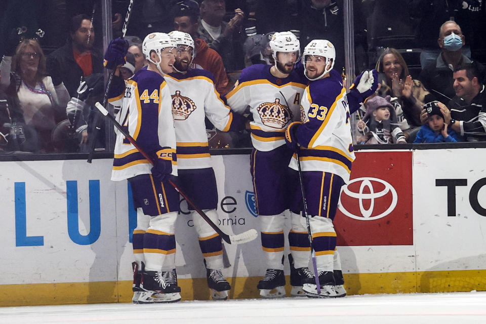 Los Angeles Kings forwards Phillip Danault, second from right, celebrates his goal with Viktor Arvidsson, right, Gabriel Vilardi , second from left, and defenseman Mikey Anderson during the first period of an NHL hockey game against the Philadelphia Flyers Saturday, Dec. 31, 2022, in Los Angeles. (AP Photo/Ringo H.W. Chiu)